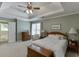 Comfortable bedroom featuring tray ceilings, neutral carpet, and natural light through the windows at 900 Meadowsong Cir, Lawrenceville, GA 30043