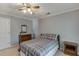 This is a cozy bedroom featuring a dresser with a mirror, a ceiling fan, and neutral decor at 900 Meadowsong Cir, Lawrenceville, GA 30043