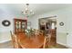 Traditional dining room with a wooden table, chandelier, and open view to the living room, perfect for Gathering meals at 900 Meadowsong Cir, Lawrenceville, GA 30043