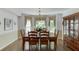 Elegant dining room boasting a chandelier, large windows, and a wooden table set for six, perfect for gatherings at 900 Meadowsong Cir, Lawrenceville, GA 30043