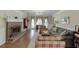 Traditional living room featuring a brick fireplace, wooden floors, and comfortable seating in a warm, inviting setting at 900 Meadowsong Cir, Lawrenceville, GA 30043