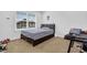 This bedroom features a large window, comfortable bed, and carpeted floors at 307 Ernest Ave, Peachtree City, GA 30269