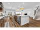 Modern kitchen with white countertops, dark cabinetry, hardwood floors, and a seamless open-concept layout at 307 Ernest Ave, Peachtree City, GA 30269
