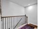View of staircase featuring wood and metal railing with view of upper level flooring at 307 Ernest Ave, Peachtree City, GA 30269