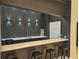 Modern bar area featuring sleek countertops, black cabinetry, stylish lighting, and convenient seating at 3777 Peachtree Ne Rd # 1512, Brookhaven, GA 30319