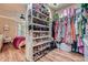 Walk-in closet with shelves of shoes and hanging rods for clothing, connected to a bedroom at 3777 Peachtree Ne Rd # 1512, Brookhaven, GA 30319