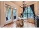 Bright dining area with a view to the balcony featuring a chandelier, and hardwood floors at 3777 Peachtree Ne Rd # 1512, Brookhaven, GA 30319
