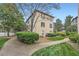 A beautiful apartment building featuring lush landscaping and charming architectural details at 3777 Peachtree Ne Rd # 1512, Brookhaven, GA 30319