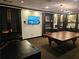 This game room is complete with a billiard table, TV, and built-in shelving at 3777 Peachtree Ne Rd # 1512, Brookhaven, GA 30319