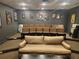 Home theater featuring tiered seating, a comfortable sofa, and movie-themed artwork on the walls at 3777 Peachtree Ne Rd # 1512, Brookhaven, GA 30319