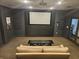 Home theater featuring projector, screen, sofa, and movie posters for entertainment at 3777 Peachtree Ne Rd # 1512, Brookhaven, GA 30319