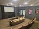 Cozy home theater room with projector, tiered seating, and movie posters for an immersive entertainment experience at 3777 Peachtree Ne Rd # 1512, Brookhaven, GA 30319