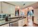 Open kitchen area showing granite counters, stainless appliances, and view to dining room at 3777 Peachtree Ne Rd # 1512, Brookhaven, GA 30319