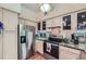 Modern kitchen with stainless steel appliances, light wood cabinets, and granite countertops at 3777 Peachtree Ne Rd # 1512, Brookhaven, GA 30319