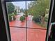 A view through a window of gated entry featuring brick pavers and manicured landscaping at 3777 Peachtree Ne Rd # 1512, Brookhaven, GA 30319