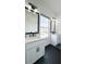 Bathroom featuring dual vanities, black hardware, hardwood floors, and natural light at 3790 Andover St, Cumming, GA 30028