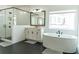 Bathroom with a free standing tub, a glass shower, and a double vanity offers spa-like luxury at 3790 Andover St, Cumming, GA 30028