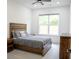 Bedroom featuring a wooden bed, wooden bedside table, carpet, and lots of natural light at 3790 Andover St, Cumming, GA 30028