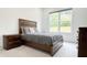 Comfortable bedroom boasts a rustic wood bed frame, lots of natural light, and tasteful decor at 3790 Andover St, Cumming, GA 30028