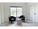 Bright bonus room is well-lit with two chairs, side table, large window, and new neutral carpet at 3790 Andover St, Cumming, GA 30028
