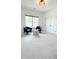 The bonus room features two accent chairs, a cube table, large windows, and recessed lighting at 3790 Andover St, Cumming, GA 30028