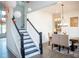 Elegant dining room adjacent to staircase with modern chandelier and decor at 3790 Andover St, Cumming, GA 30028