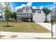 Beautiful two-story white home with black shutters, stone accents, and a well-manicured lawn at 3790 Andover St, Cumming, GA 30028