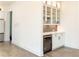 Kitchenette features granite counters, wine cooler, and tile backsplash at 3790 Andover St, Cumming, GA 30028