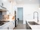 Bright kitchen with island, stainless appliances, and herringbone backsplash, open to another room at 3790 Andover St, Cumming, GA 30028