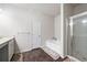 Bathroom featuring wood flooring, bathtub, and a glass-enclosed shower at 406 Crescent Woode Dr, Dallas, GA 30157