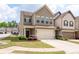 Charming two-story townhome featuring a two-car garage and manicured front lawn with a cozy entrance at 406 Crescent Woode Dr, Dallas, GA 30157