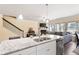 Bright kitchen showcasing granite countertops, stainless steel appliances, and open view to the living area at 406 Crescent Woode Dr, Dallas, GA 30157