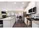 Open-concept kitchen with granite counters, stainless appliances, and an adjacent living and dining area at 406 Crescent Woode Dr, Dallas, GA 30157