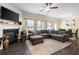 Open-concept living room with a fireplace, ceiling fan and lots of natural light at 406 Crescent Woode Dr, Dallas, GA 30157