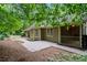 Exterior view of home, patio, and walkway surrounded by lush greenery at 5755 Hendrix Rd, Cumming, GA 30040