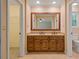 Bathroom featuring a double sink vanity, tile flooring, and a large framed mirror at 5755 Hendrix Rd, Cumming, GA 30040