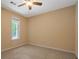 Comfortable bedroom with neutral carpet, window overlooking greenery and ceiling fan at 5755 Hendrix Rd, Cumming, GA 30040