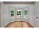 Charming breakfast nook area bathed in natural light with hardwood floors and wooded views at 5755 Hendrix Rd, Cumming, GA 30040