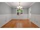 Formal dining room with hardwood floors, wainscoting, chandelier, and neutral wall color at 5755 Hendrix Rd, Cumming, GA 30040