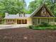 Charming home featuring a shingle roof, manicured landscaping, and a two-car garage at 5755 Hendrix Rd, Cumming, GA 30040