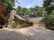 Charming home boasting a well-maintained roof, attached garage, and beautiful surrounding trees at 5755 Hendrix Rd, Cumming, GA 30040