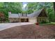 Charming home with attached two-car garage, complemented by well-maintained landscaping and a private driveway at 5755 Hendrix Rd, Cumming, GA 30040