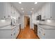 Galley kitchen featuring granite countertops, stainless steel appliances, and hardwood floors at 5755 Hendrix Rd, Cumming, GA 30040