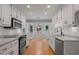 Bright kitchen features white cabinets, granite counters, and a breakfast nook with wooded view at 5755 Hendrix Rd, Cumming, GA 30040