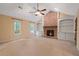 Inviting living room featuring a ceiling fan, brick fireplace with built-ins, and cozy carpet at 5755 Hendrix Rd, Cumming, GA 30040