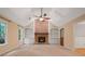 Spacious living room with a vaulted ceiling, brick fireplace, and built-in shelving at 5755 Hendrix Rd, Cumming, GA 30040