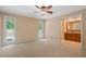 Spacious main bedroom with neutral carpet, large windows and en-suite bathroom at 5755 Hendrix Rd, Cumming, GA 30040
