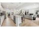 Open-concept kitchen with granite countertops and stainless steel appliances leads to the living room at 732 Hedwig Dr, Mcdonough, GA 30252