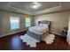 Serene bedroom featuring a tray ceiling, neutral color palette and cozy rug at 10650 Allon Cv # 137, Alpharetta, GA 30022