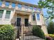 Traditional townhome with brick facade, steps and black iron railings at 10650 Allon Cv # 137, Alpharetta, GA 30022